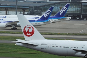 October 4th, 2013 : Tokyo, Japan - Airplanes of All Nippon Airlines, or ANA, and Japan Airlines, or JAL, were seen at Tokyo International Airport, Ota, Tokyo, Japan on October 4, 2013. The airport would increase number of airliners on international flights next year, and Ministry of Land, Infrastructure, Transport and Tourism decided two days ago decided to give ANA 11 flights and JAL five. (Photo by Koichiro Suzuki/AFLO)